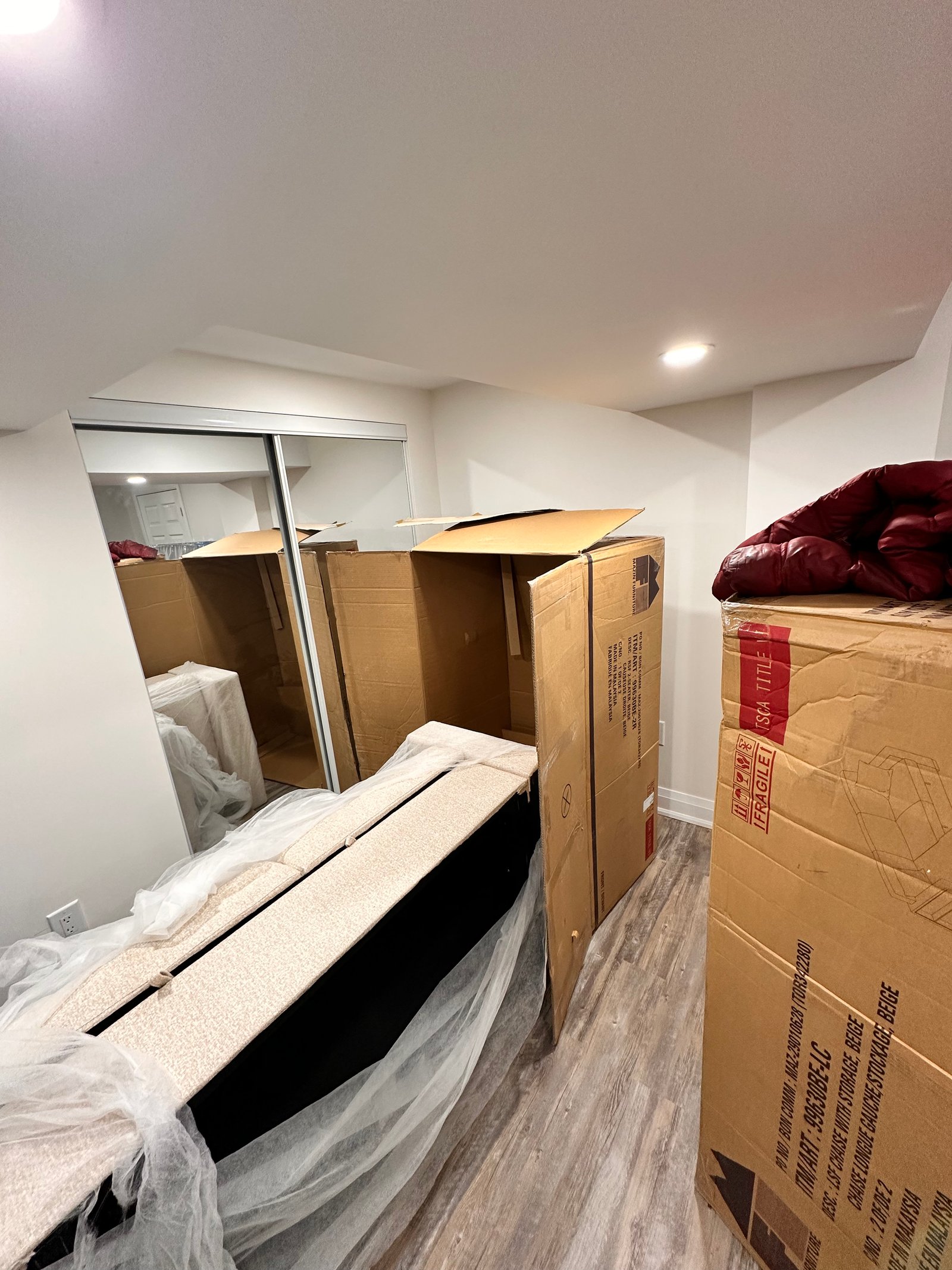 Finished hallway with paneling and lighting